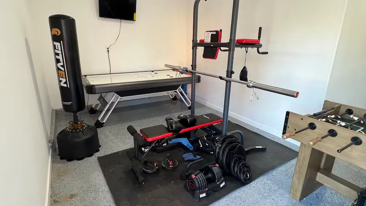 Gym room with weights, boxing bag and arcade at Serenta Tracy CA