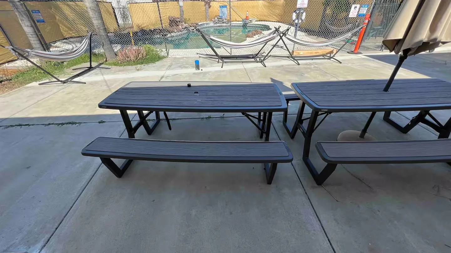 Outdoor patio with dining area and hammocks at Serenta Tracy CA