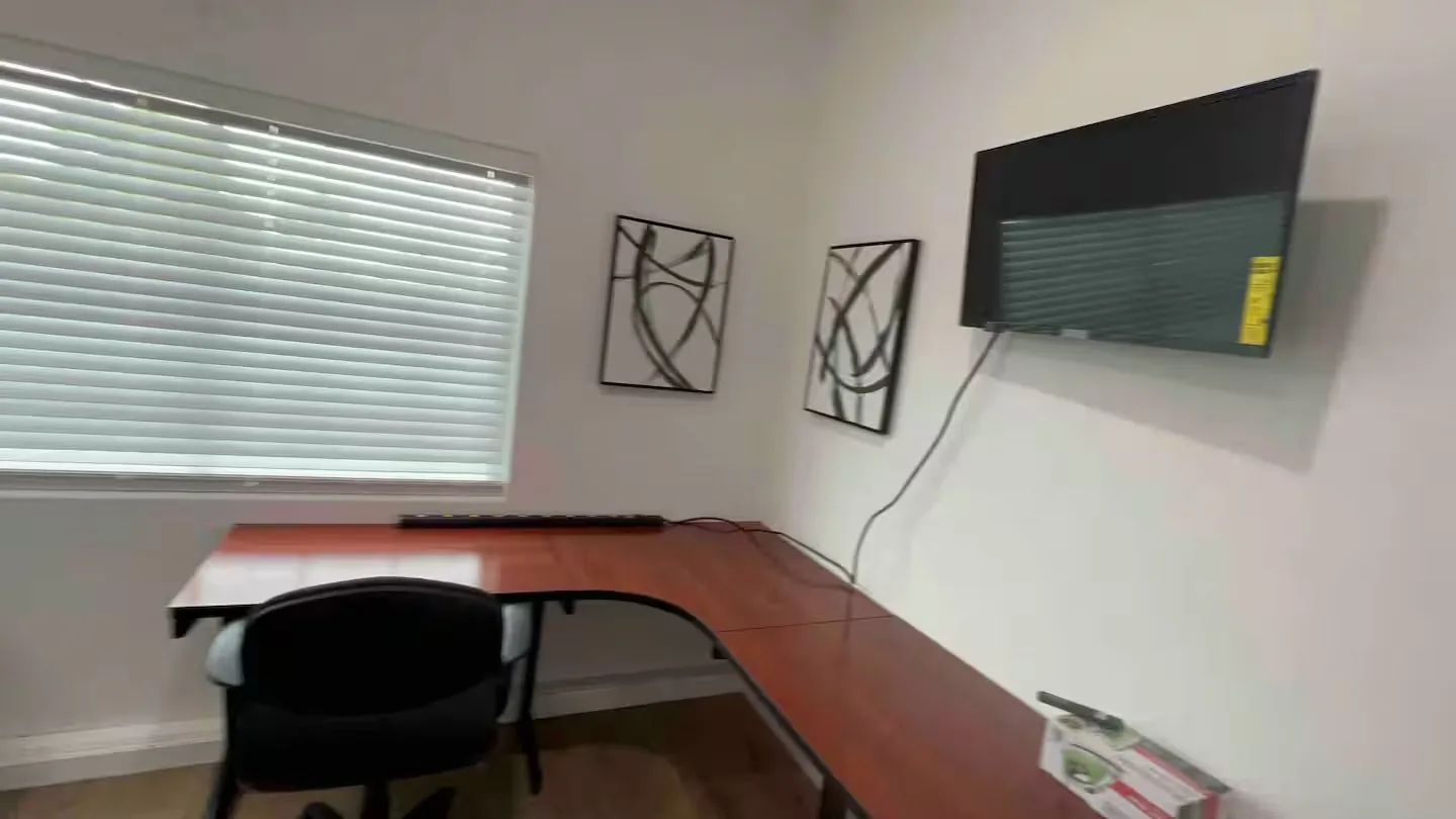 Workspace with desk and mounted TV at Serenta vacation rental Tracy CA